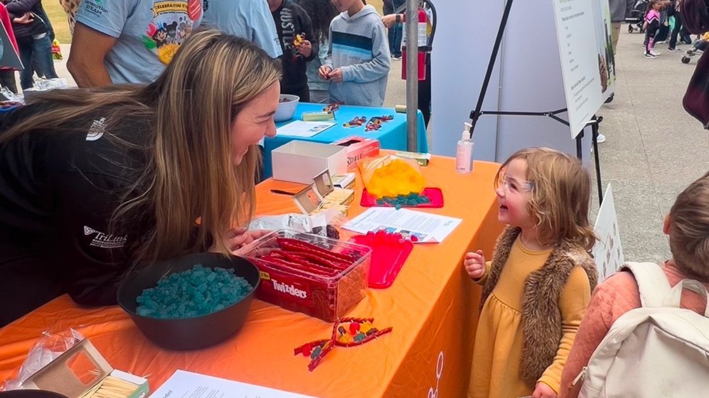 Woman laughing with a child at a Maravai event