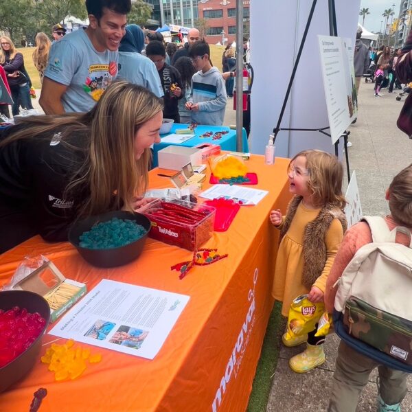 Woman laughing with a child at a Maravai event