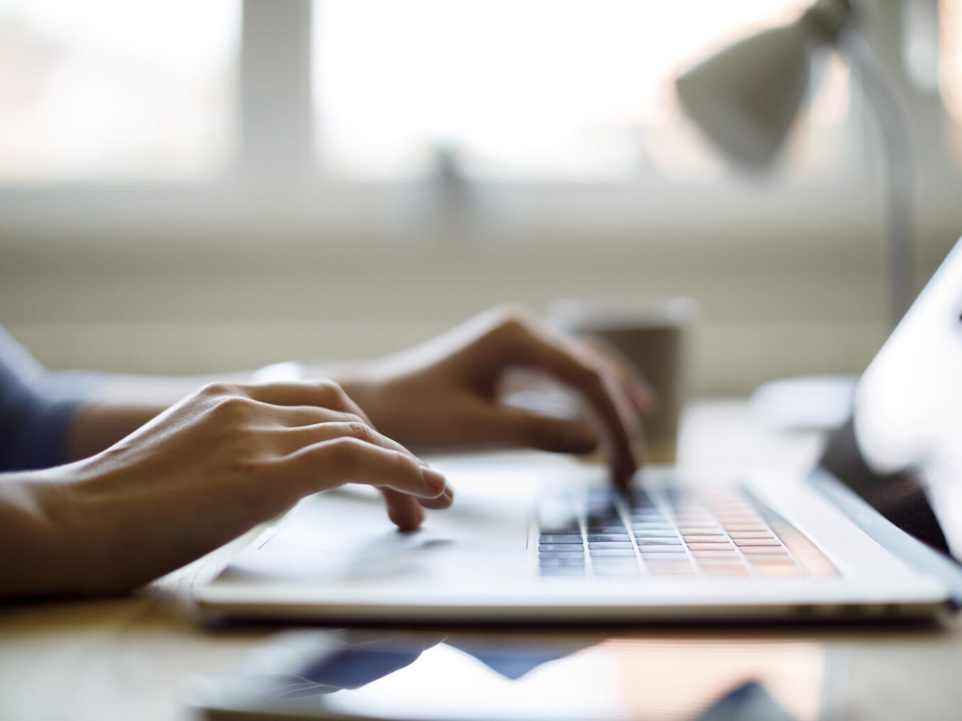 hands typing on a laptop